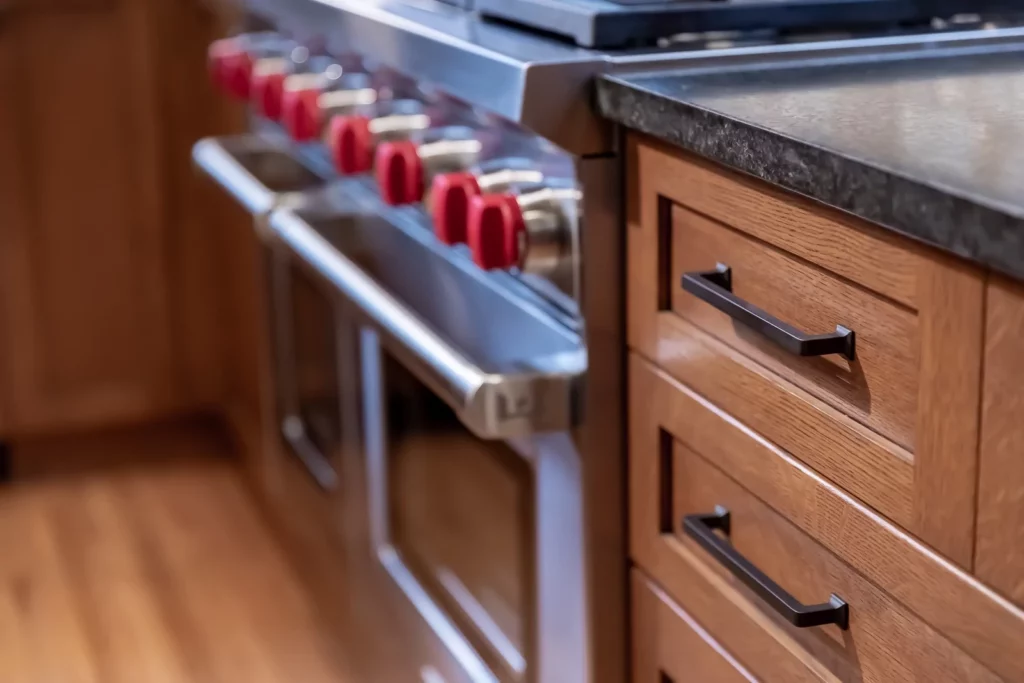 Kitchen cabinetry meeting with a stove