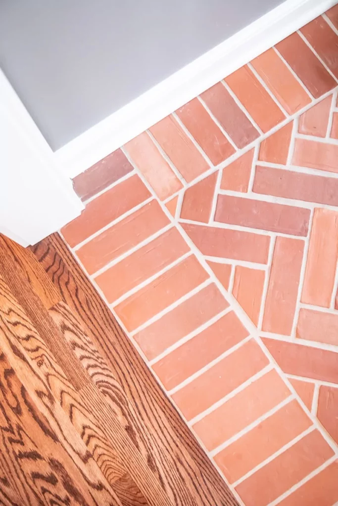 Brick tile arranged in a herringbone pattern