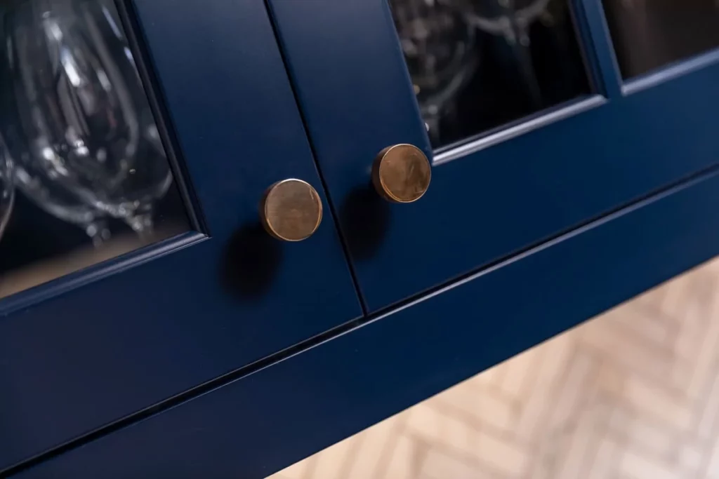 Deep blue cabinets with brown handles